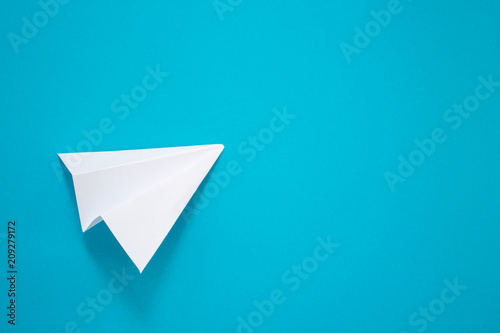 White paper plane on a blue background. Telegram symbol