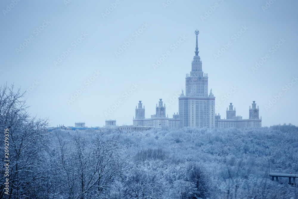 After heavy snowfall in Moscow snow-covered Lomonosov Moscow State University and park around it, aerial view