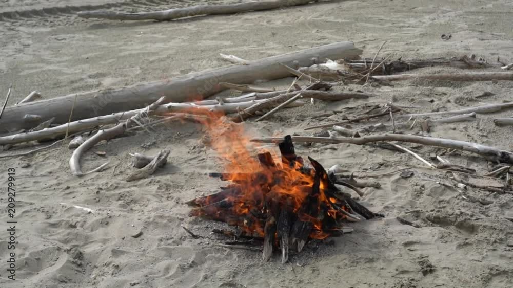 Panorama from the fire on the beach to the water and shore, handheld video Panorama from the fire on the beach to the water and shore, handheld video