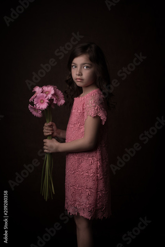 Painterly studio portrait of girl in pink with flowers photo