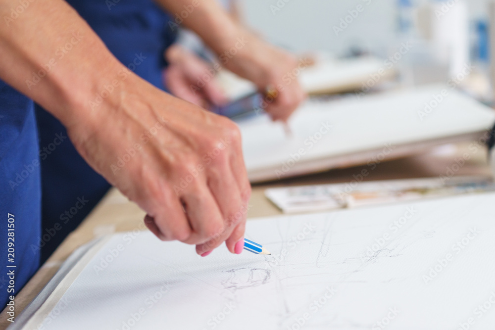 Artist sketches a pencil in a school of painting, preparing a blank canvas for the creation of a painting. Artist sketches a pencil in a school of painting, preparing a blank canvas for the creation of a painting.