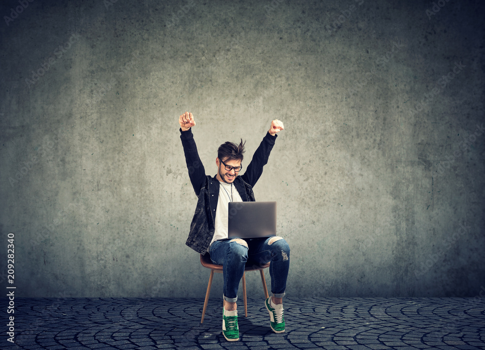 Successful guy with laptop excited with win Successful guy with laptop excited with win