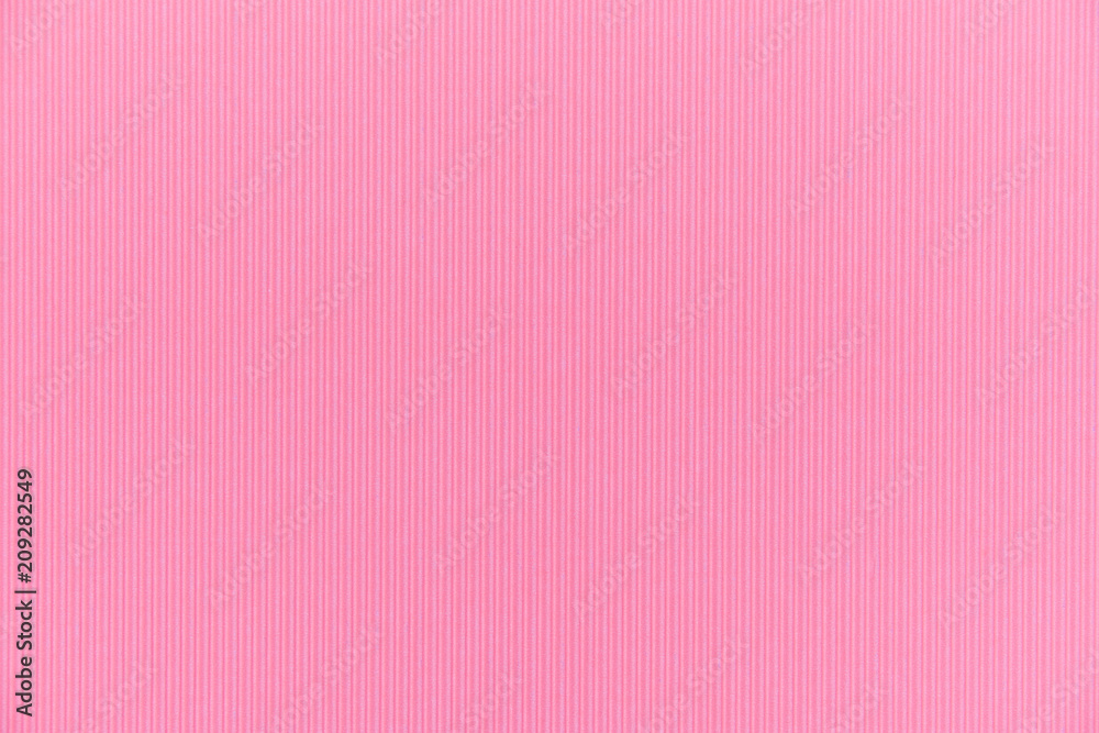 Backdrop texture of pink paper cardboard with vertical corrugated lines.
