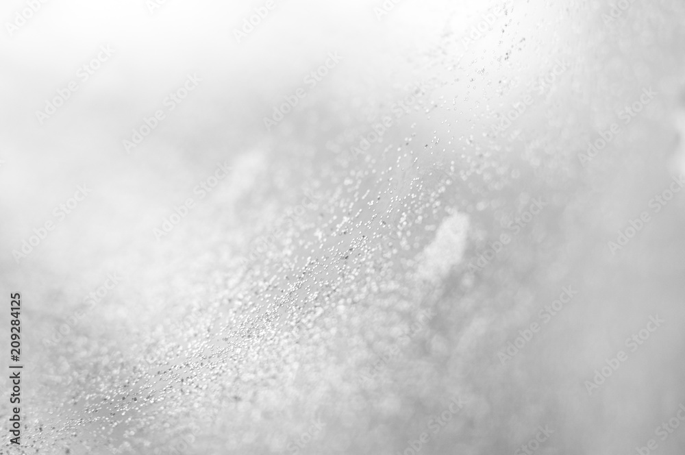 Abstract of Bright and sparkling bokeh background. silver and diamond dust bokeh blurred lighting from glitter texture Abstract of Bright and sparkling bokeh background. silver and diamond dust bokeh blurred lighting from glitter texture