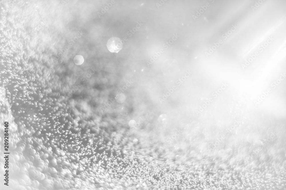 Abstract of Bright and sparkling bokeh background. silver and diamond dust bokeh blurred lighting from glitter texture Abstract of Bright and sparkling bokeh background. silver and diamond dust bokeh blurred lighting from glitter texture