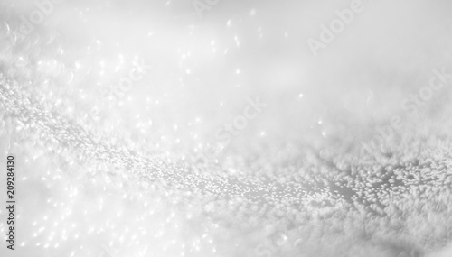 Abstract of Bright and sparkling bokeh background. silver and diamond dust bokeh blurred lighting from glitter texture