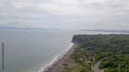 Beautiful aerial view of the beach with parapenting in the horizon photo