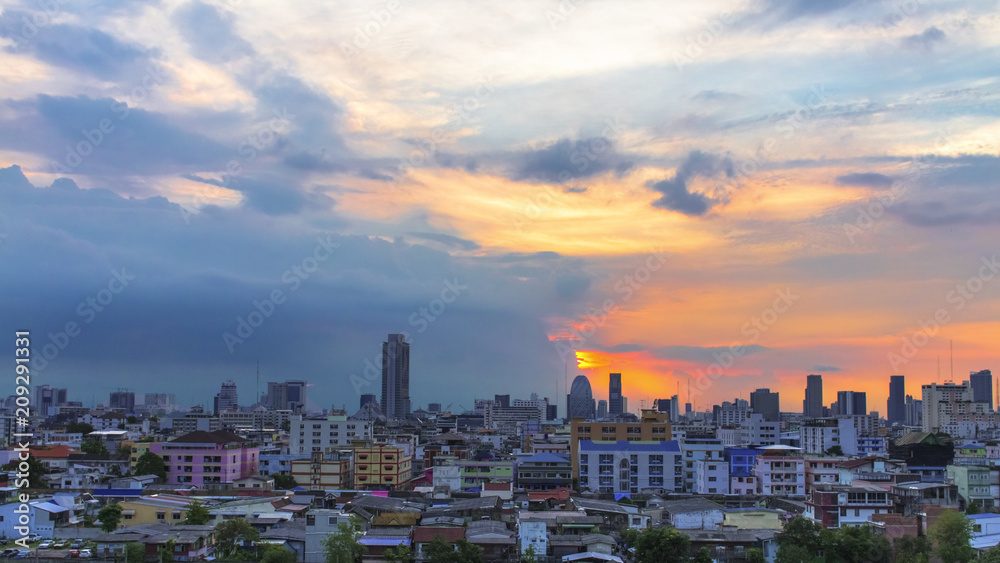 Bird view over cityscape with sunset and clouds in the evening.Panorama copy space.Bangkok.Pastel tone.