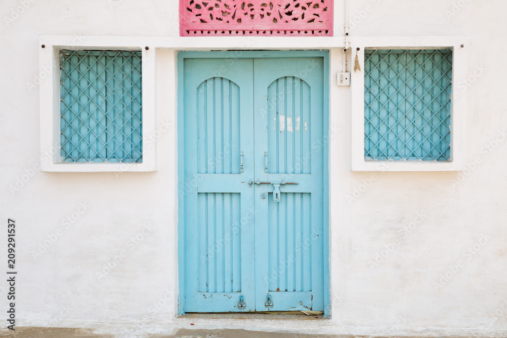 Blue door and window, house exterior in India