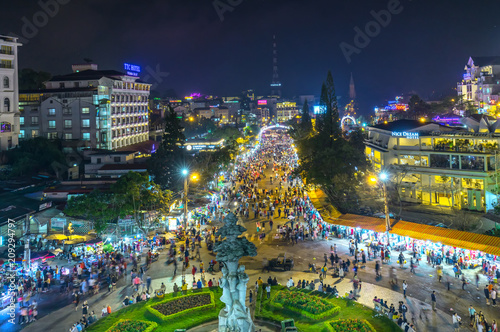 Da Lat, Vietnam - May 12th, 2017: Da Lat Market night skyline night view with lights attracts thousands of people walking along the road shopping crowded bustle of city tourism in Da Lat, Vietnam