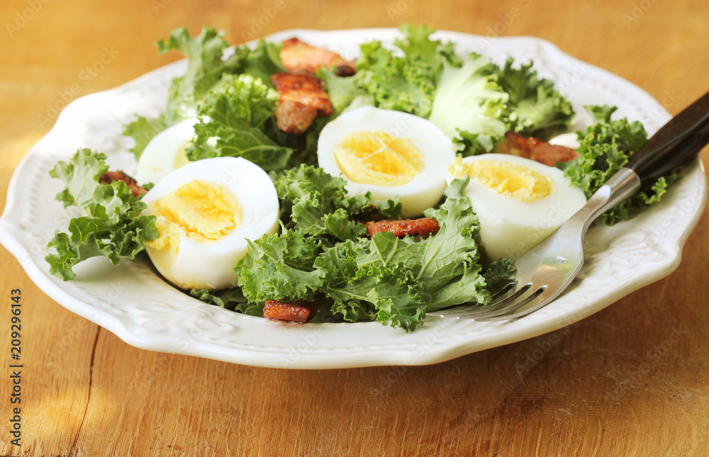 Fresh healthy salad with kale, chrispy bacon and egg Fresh healthy salad with kale, chrispy bacon and egg