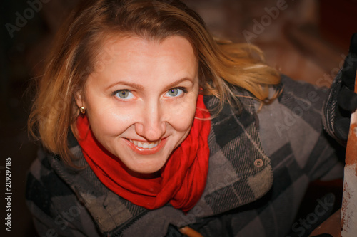 Night portrait blonde girl in a warm coat