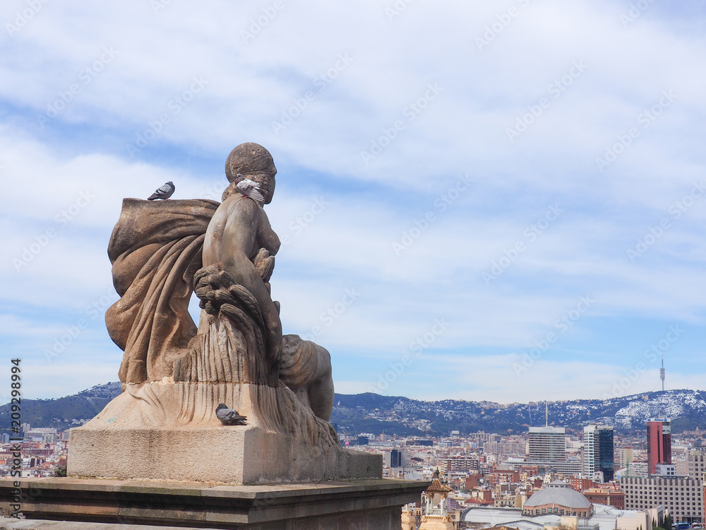Photo taken in Barcelona, Spain on March 20, 2018. Statue of a woman looking towards the city of Barcelona