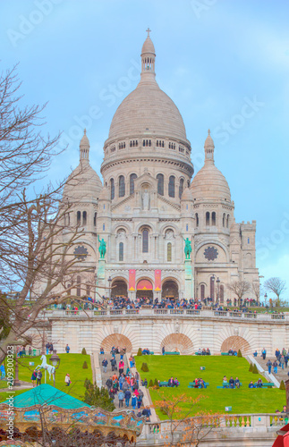 Unidentified tourists visiting Sacre Coeur Cathedral on Montmartre. Sacre Coeur Cathedral is a Roman Catholic church,