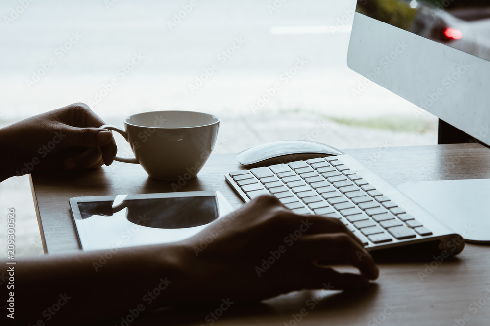 Fototapeta premium working day in office,workplace table and office desk close up hand hold on coffee cup