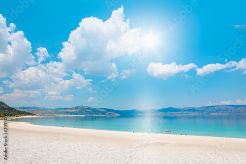 Holidaymakers sunbathing at Salda white beach  - Salda Lake, Turkey