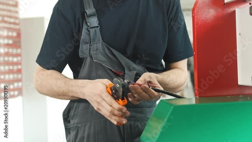 Hands of electrician works with electric wires photo