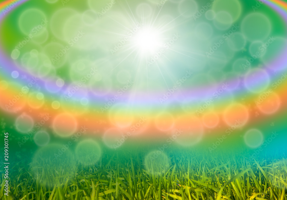 Green grass background with bokeh and rainbow