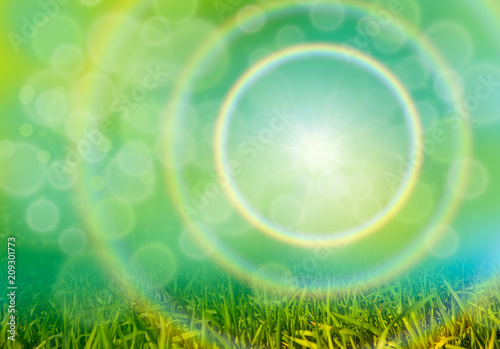 Green grass background with bokeh and rainbow