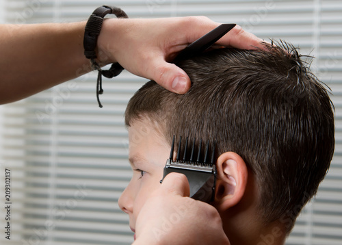 the hairdresser does the hair for the child, the clippers