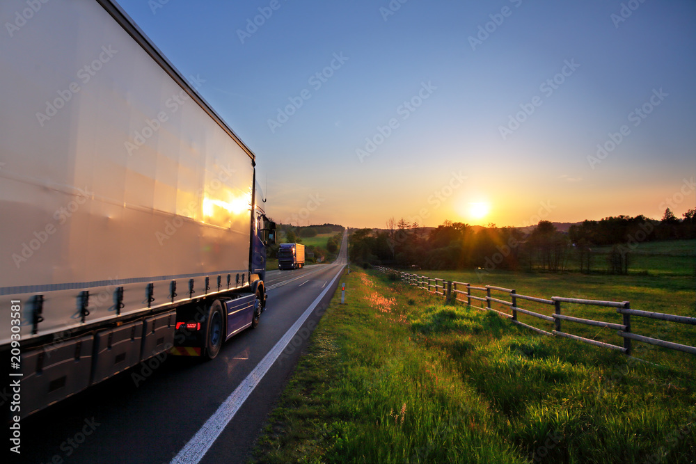 Truck transportation on the road at sunset