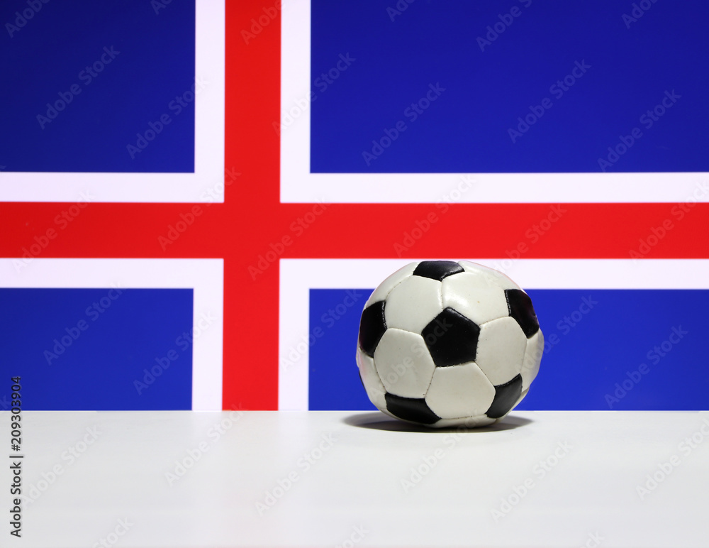 Obraz premium Small football on the white floor and red and white color of cross on blue of Iceland nation flag background. The concept of sport.