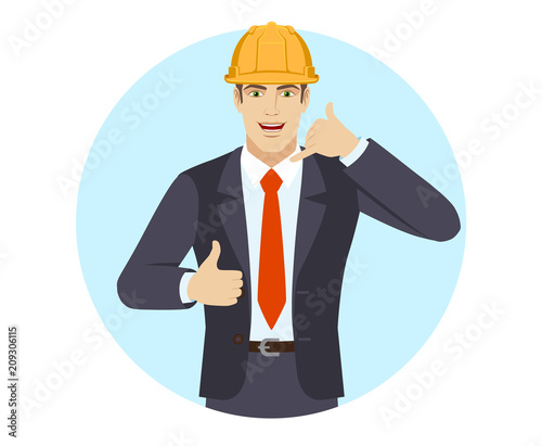 Businessman in construction helmet showing a call me sign and showing thumb up