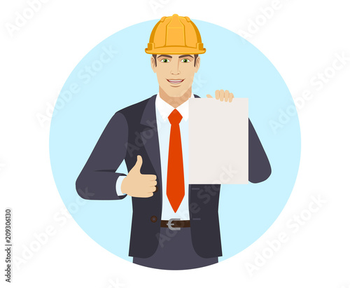 Businessman in construction helmet showing thumb up and showing the blank paper