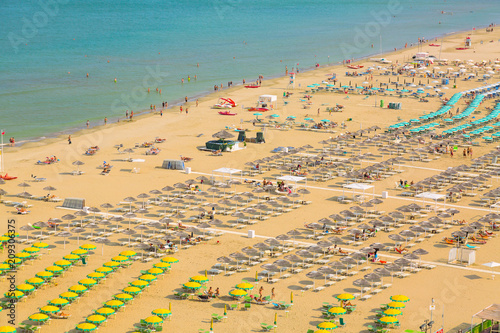 Aerial view of Rimini beach with people and blue water. Summer vacation concept. © Nikolay N. Antonov