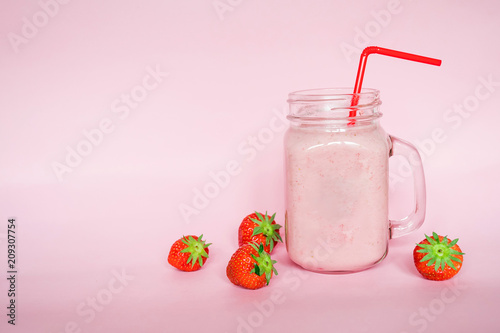 Soft focust straweberry milkshake in glass with red pipe and Fruit strawberry with green leaves on background soft pink purple, food tasty for breakfast good for healthy and helping to diet photo