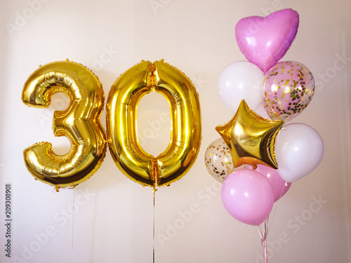 Composition of helium balloons white, pink, transparent with confetti, as well as a gold star and a large figure of thirty golden colors. Gift for 30 years for a girl