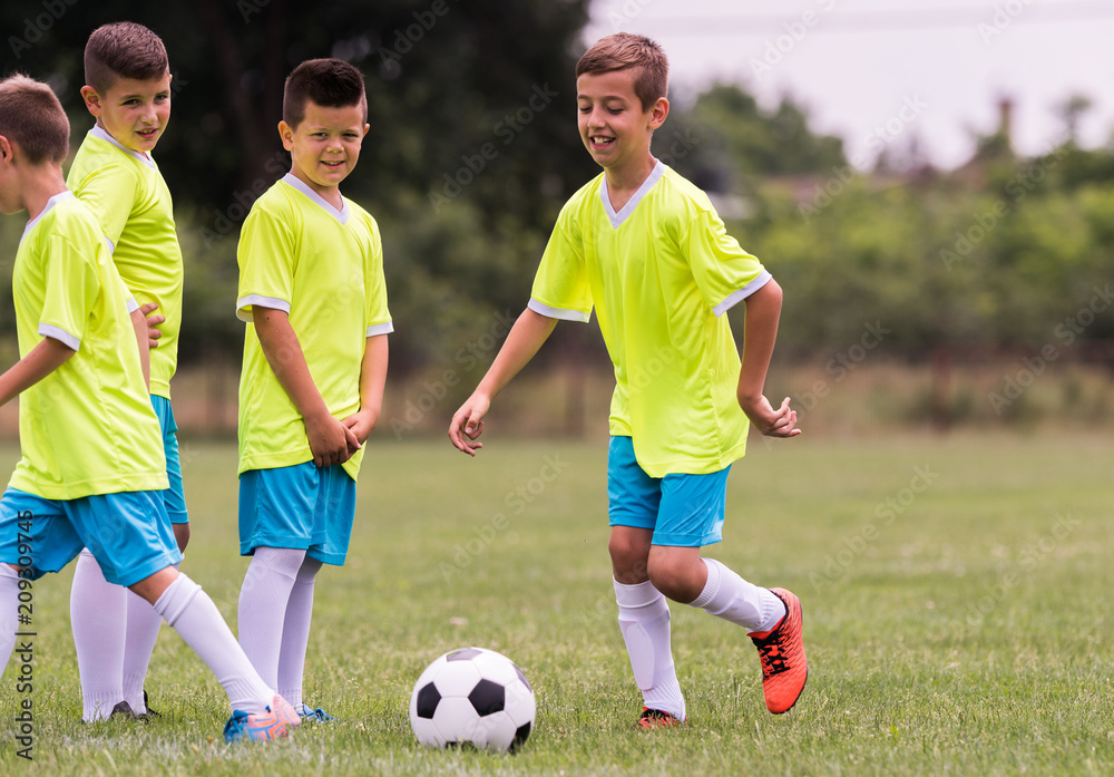 Young children players football match on soccer field