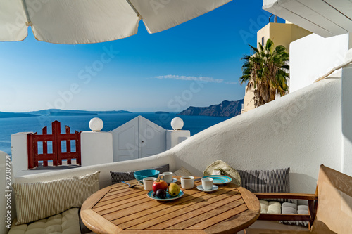 Fototapeta Naklejka Na Ścianę i Meble -  Breakfast in Paradise - on a terrace in Santorini, Greece