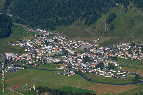 Paragliding above swiss moutnain village Celerina in the Upper Engadin photo