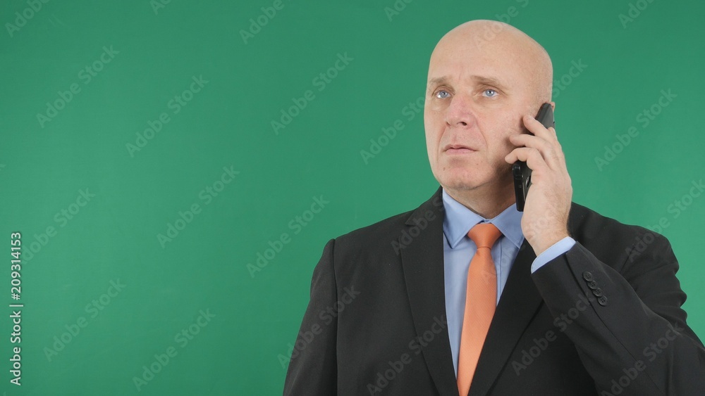 Serious Businessman Image Using a Cell Phone Serious Businessman Image Using a Cell Phone