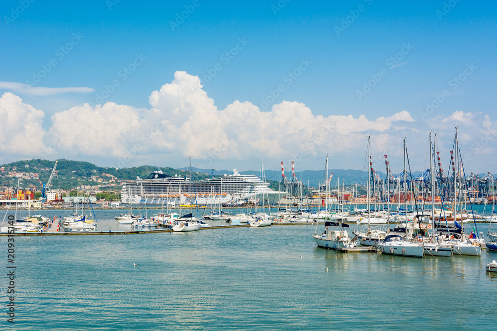 Busy sea port with ships and boats docked in.