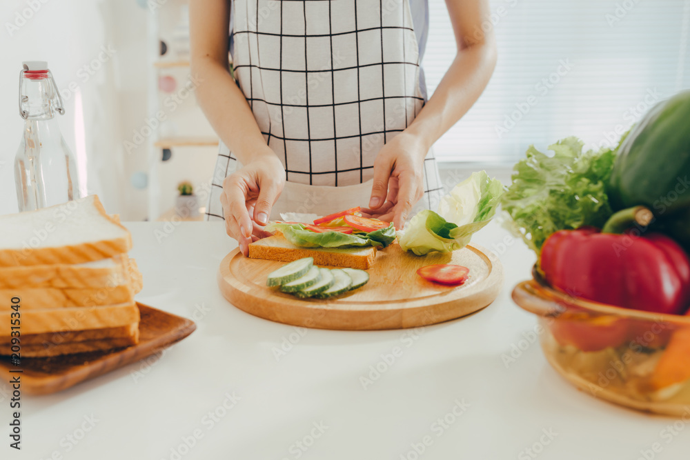 Woman apron preparing a breakfast in the kitchen Woman apron preparing a breakfast in the kitchen