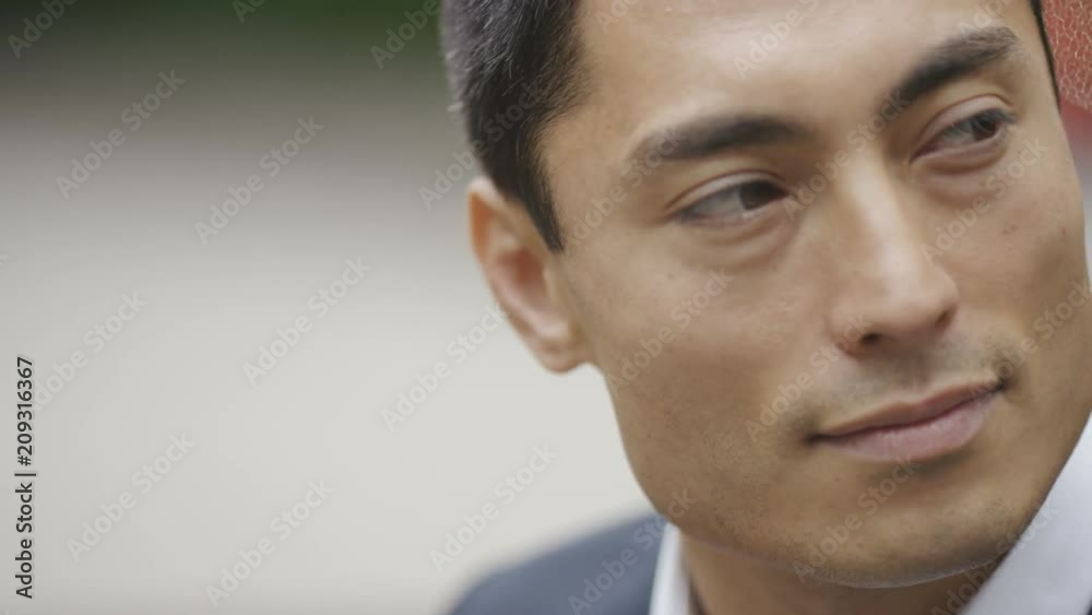 Portrait of handsome asian man looking around, in slow motion Portrait of handsome asian man looking around, in slow motion