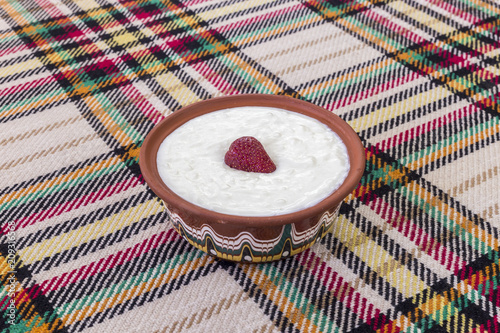 Strawberry in a bowl of yogurt photo