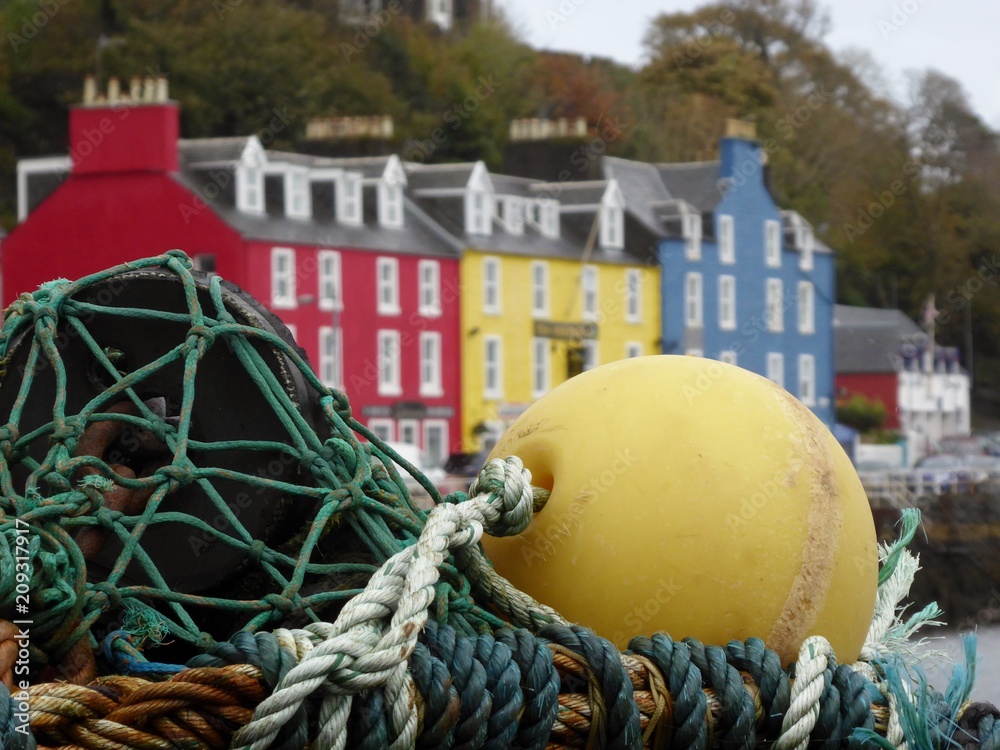 Tobermory on fishing Mull, Scotland, fishing equipment with colourful houses in the background, shallow depth of field Tobermory on fishing Mull, Scotland, fishing equipment with colourful houses in the background, shallow depth of field
