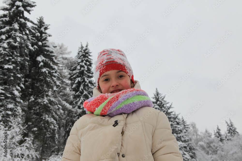 The frame depicts a winter forest, trees and pine trees. A child is playing with snow. Walk in the winter forest on vacation. The frame depicts a winter forest, trees and pine trees. A child is playing with snow. Walk in the winter forest on vacation.