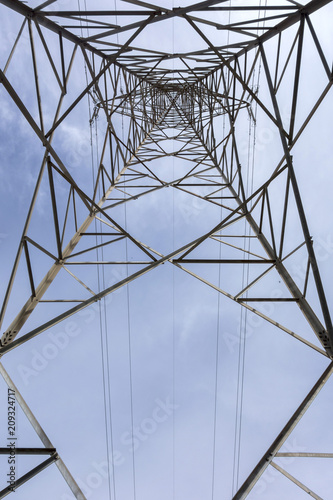 Electricity tower seen from below and blue sky.