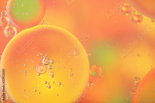 Abstract colorful background with macro of oil drops on water