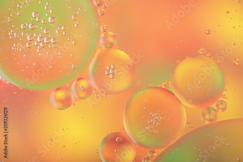 Abstract colorful background with macro of oil drops on water