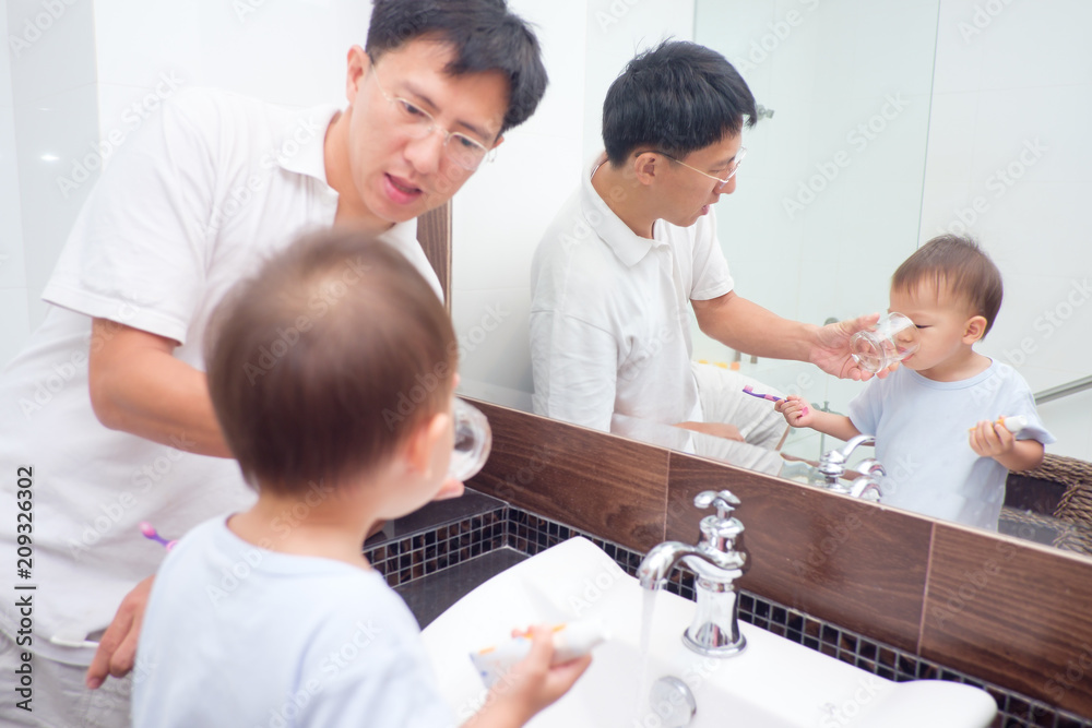 Asian Father teaching kid teeth brushing, Cute little 2 years old