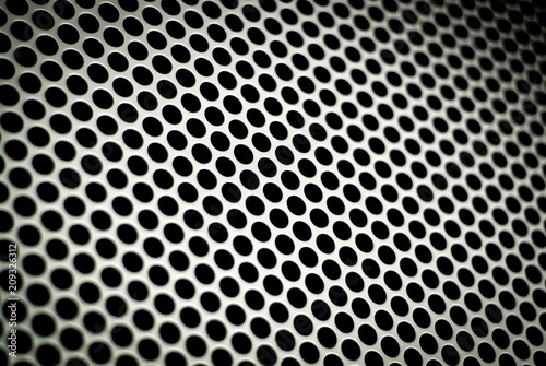 Metal protecting mesh on a loudspeaker cabinet. Texture.