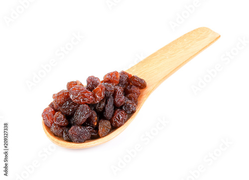 raisin on wood spoon isolated on white background