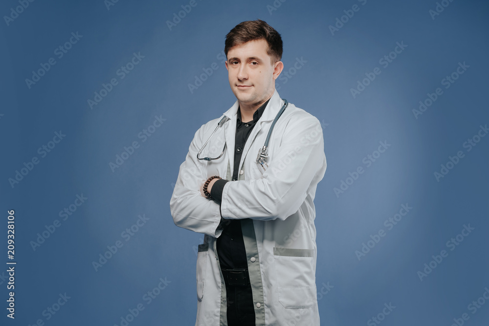 Portrait of confident young medical doctor. Young doctor man with stethoscope.doctor in a medical dressing gown Portrait of confident young medical doctor. Young doctor man with stethoscope.doctor in a medical dressing gown