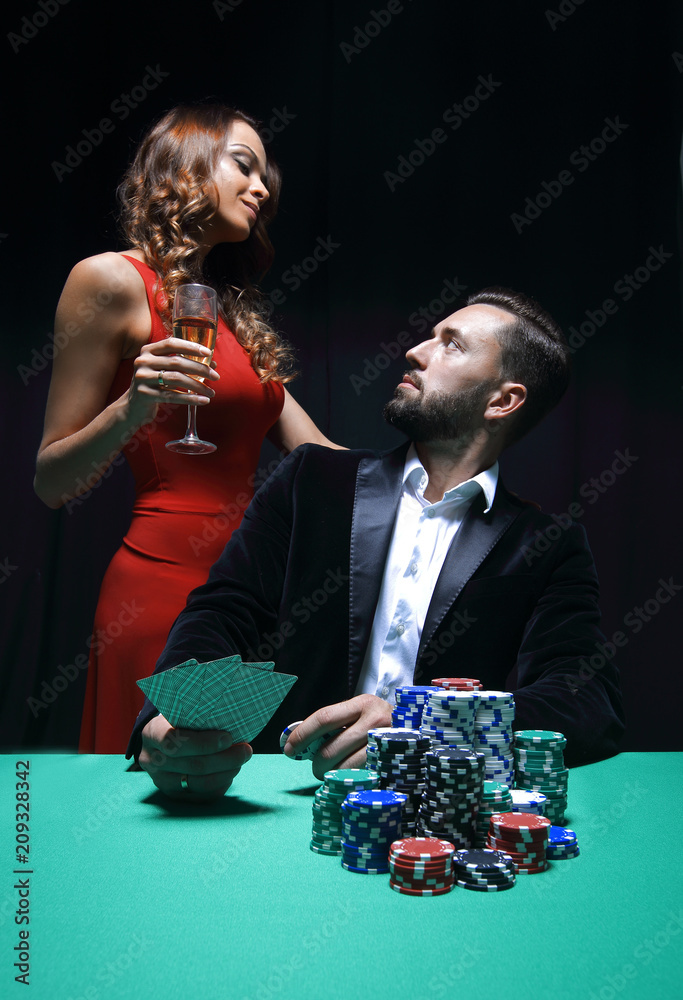 beautiful couple looking at playing cards at poker beautiful couple looking at playing cards at poker