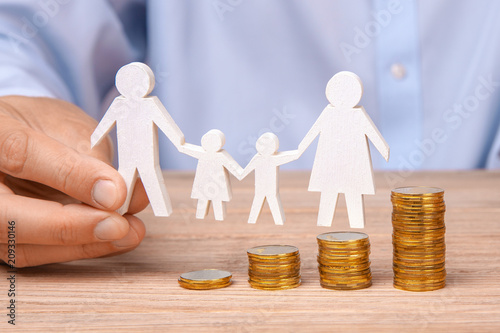 Budget of the family. Coins pile and the symbol of the family 